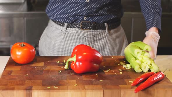 Man Cutting a Red Pepper