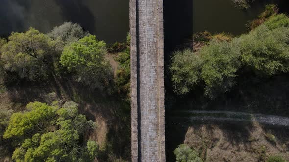 Roman stone bridge over Seda river, Vila Formosa in Portugal. Aerial top-down forward