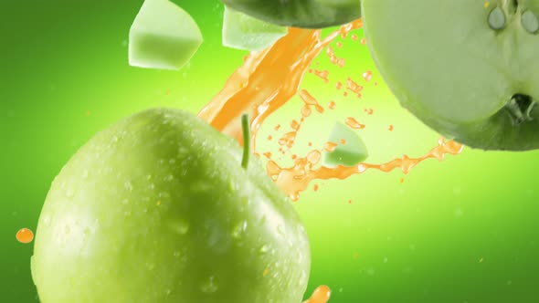 Green Apple with Slices Falling on Green Background