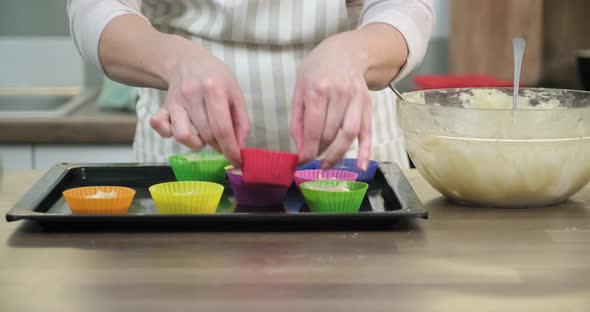 Womans Hands with Cookie Cutters with Muffin Dough