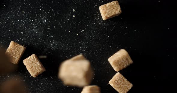 Cubes of Brown Sugar Fall on the Table
