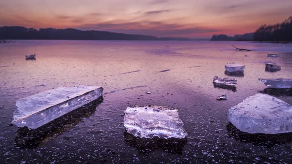 Stunning dusk with cracked ice on frozen lake at winter, timelapse, 4k alt