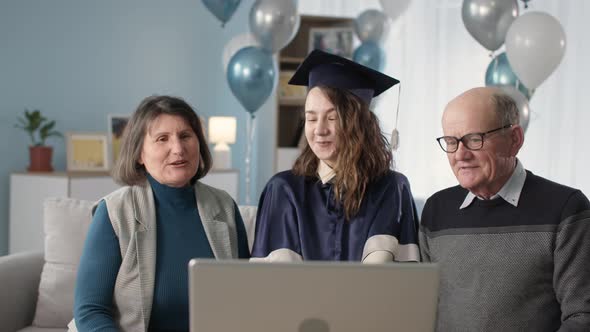 Online Graduation Ceremony Loving Parents and Graduate Daughter Celebrating Graduation Via Video