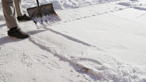 Shoveling Snow with a Shovel in Winter Closeup in Slow Motion