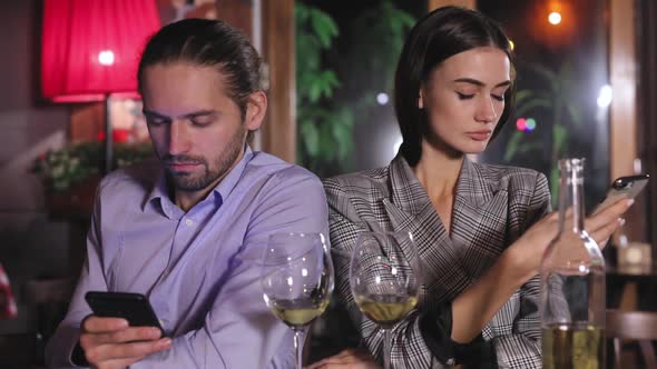 Communication Problem. People Using Phone On Date At Restaurant