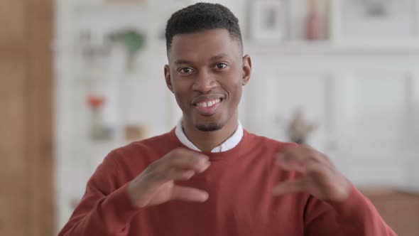 Portrait of African Man Showing Heart Sign by Hand