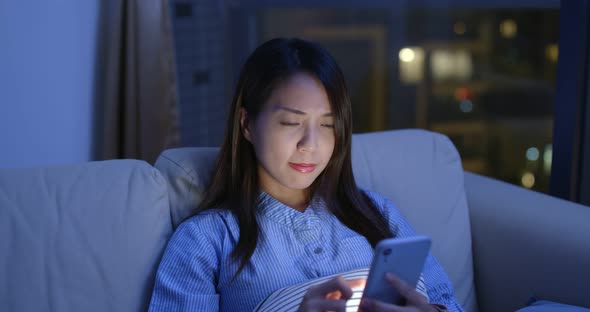 Woman use of mobile phone at night and feeling eye pain and dry