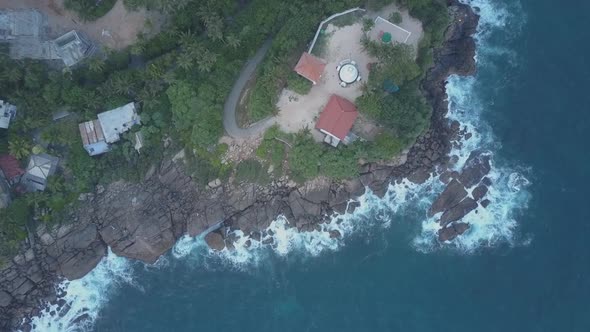 Camera Rises Above Hotel on Steepy Cliff Near Calm Ocean