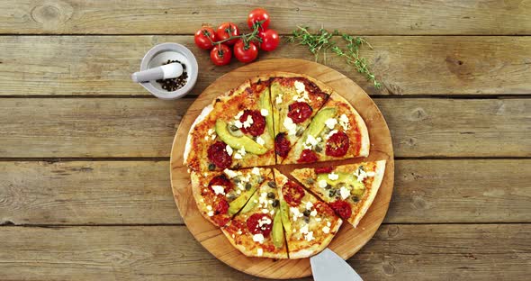 Delicious pizza with ingredients on wooden table