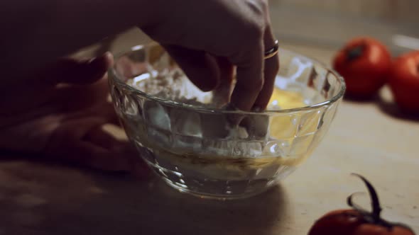 Closeup Female Hand Mixing Food Ingredients in Glass Bowl