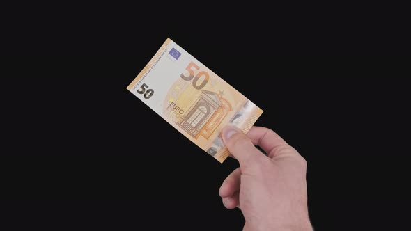 Male Hand Shows a Banknote of 50 Euros with Alpha Channel