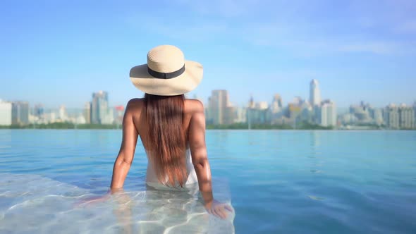 Young asian woman enjoy around outdoor swimming pool for leisure