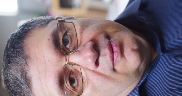 Closeup of a Middleaged Office Worker  He Takes Off His Glasses and Rubs the Bridge of His Nose