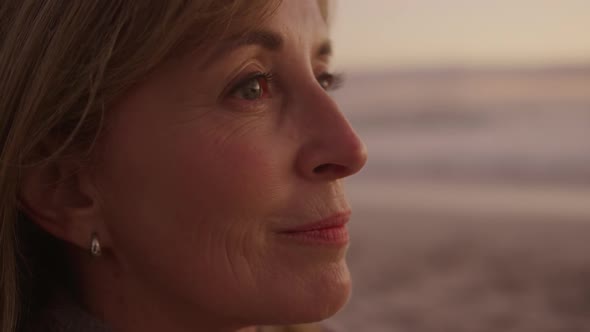 Active senior woman sitting on beach