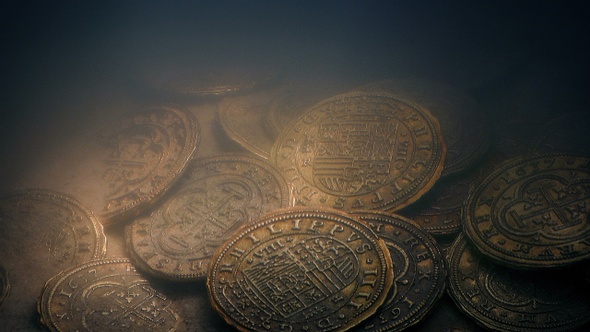 Torch Lights Up Gold Coins Underwater