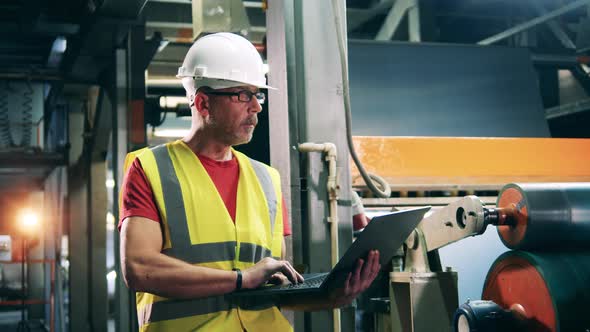 Factory Worker Is Monitoring Industrial Equipment