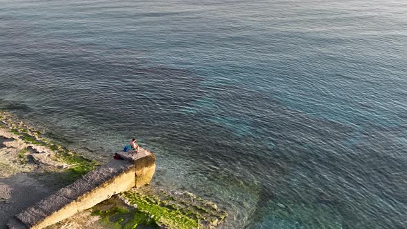 A fisherman catches fish in the sea aerial view 4 K