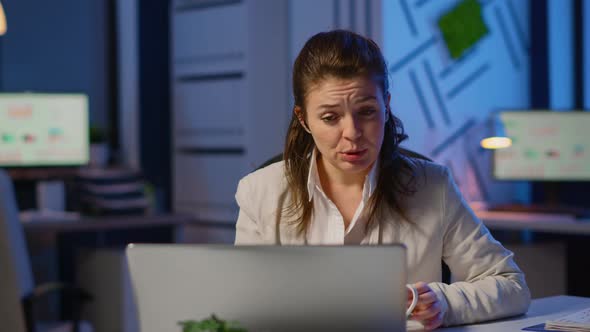 Business Woman Using Wireless Headphone Duing Video Conference