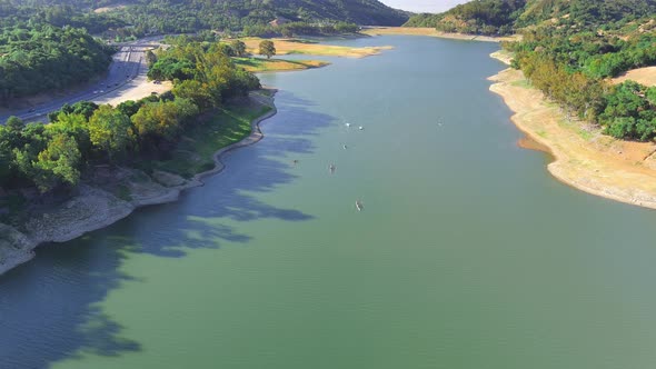 Rowing Teams Sculling On Artificial Lake Of Lexington Reservoir In California. aerial