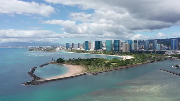 Descending close-up aerial shot of Magic Beach in Honolulu on the island of O'ahu, Hawaii. 4K