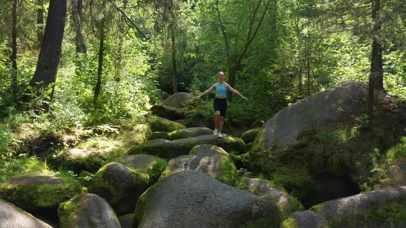 A Girl Practices Balance and Yoga in the Forest