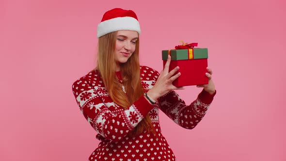 Happy Girl Wears Red Christmas Holiday Sweater Received Present Interested in What Inside Gift Box