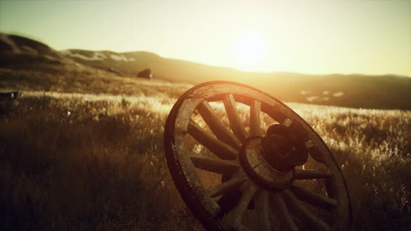 Old Wooden Wheel on the Hill at Sunset