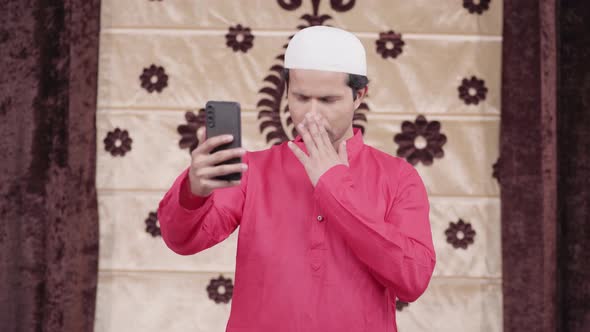 Sad Muslim man talking on a video call