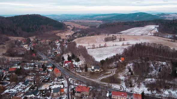 Winter Landscape with Village Near Mountains