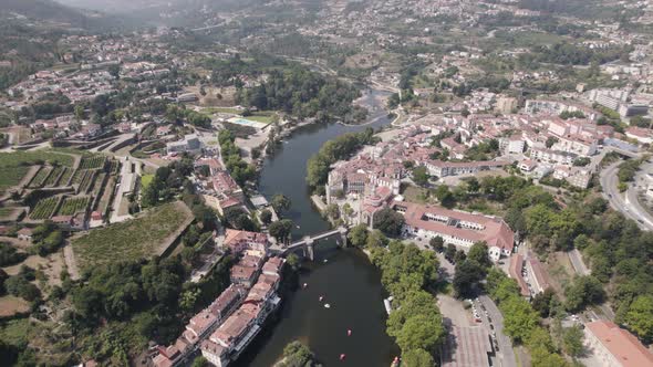 Rooftops of Amarante town surrounding Tamega river, aerial ascend view