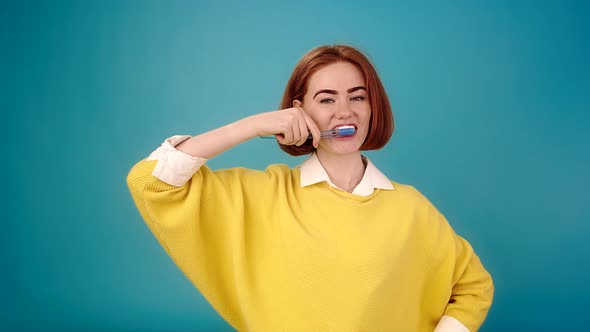 Young Woman Brushes Teeth