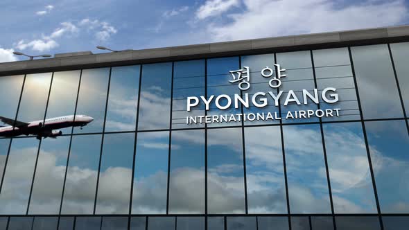 Airplane landing at Pyongyang North Korea airport mirrored in terminal