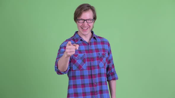 Happy Young Handsome Hipster Man Pointing at Camera