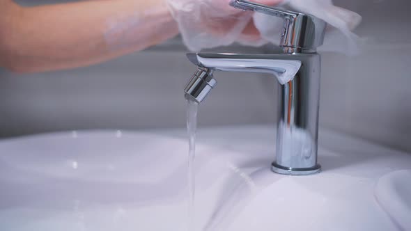 Faucet in the Bathroom with Household Chemicals, Sanitary Treatment and Disinfection of the Virus