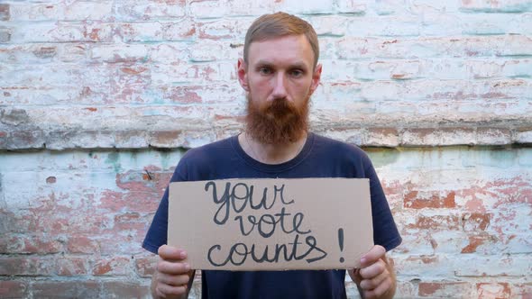 Man shows cardboard with Your Vote Counts sign Make the political choice Presidential elections 4K