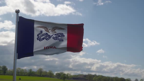Iowa Flag on a Flagpole Waving in the Wind in the Sky
