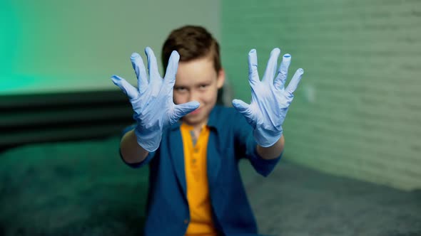 Boy wears medical rubber gloves.