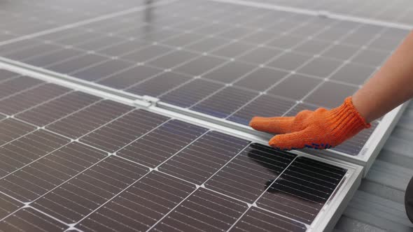 Unrecognizable Man Glove Wiping Solar Panel From Dust on Sunny Day