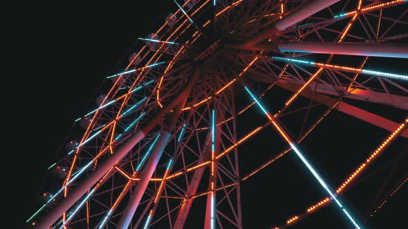 Ferris Wheel with Lights Rotates at Night