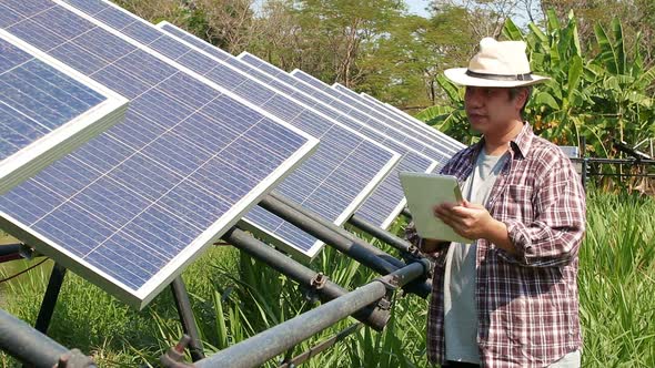 farming man holding a tablet Used to control solar panels