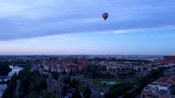 Hot air balloon in the sky over the beautiful spanish city of Salamanca at dusk.