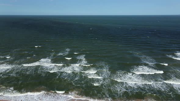 Drone Flight Over the Azure Sea with Waves and Sandy Coast