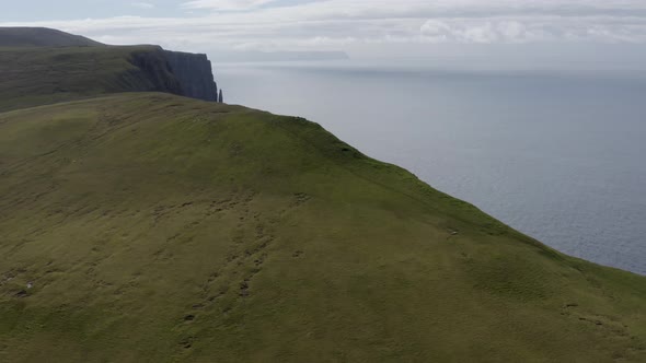 Drone Along Green Landscape To Suduroy Cliffs