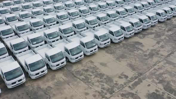 Aerial top view of new truck cars parking for sale stock lot row, dealer inventory