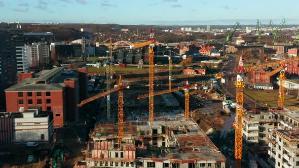 Aerial View of a Construction Site with Cranes and Heavy Machinery alt
