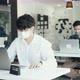 Asian colleague works while wearing a mask in the office during COVID-19. - VideoHive Item for Sale