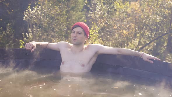 Relaxed Male Relaxing in Hot Tub Jacuzzi Outdoor.