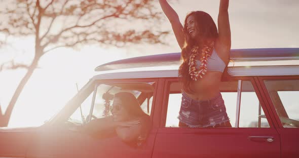 Leaning out of a vintage car happily