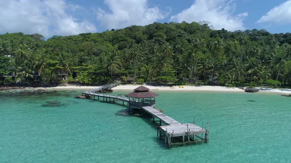 Aerial Orbit of gazebo on a dock out in the ocean on a perfect tropical island, Koh Kood, Thailand