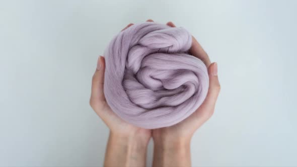 Stop Motion Colored Balls of Merino Wool Change in Female Hands Closeup Soft Focus